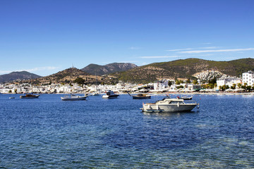 Fototapeta na wymiar Luxury yachts, sailing and fishing boats in Bodrum bay. It is a city on the Bodrum Peninsula, stretching from Turkey's southwest coast into the Aegean Sea.
