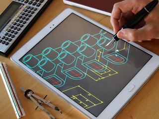 designer working on cad blueprint using tablet computer tool