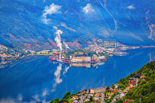 Odda, Eitrheim, small Norwegian town by Sorfjorden. View from above at old ironworks, metallurgical plant. Harmony habitation of people and nature. Norway, northern Europe, popular travel destination.