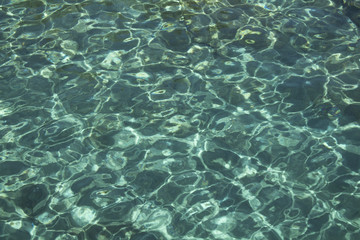 Close up view of crystal clear turquoise water with sand ground in Bodrum city.