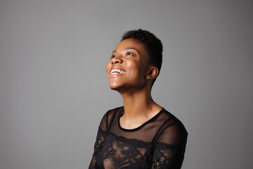 woman watching to the light in a grey background