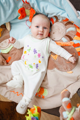 Cheerful baby lies on his back