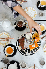 Tea time, Hands of people take desserts and tea on table