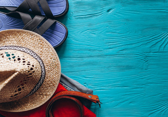 Top view of travel accessories set on wooden blue background with copy space