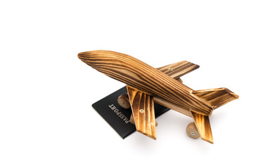 airplane model on top of a passport on white background