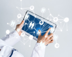 Close of female doctor hands working with tablet pc computer