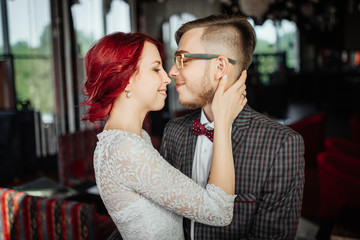 Naklejka premium Luxury stylish wedding. Wedding day. Portrait of beautiful bride and elegant groom after wedding ceremony. Luxury bridal dress and bouquet of flowers. Close-up.