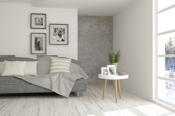 White room with sofa and winter landscape in window. Scandinavian interior design. 3D illustration