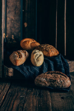 Different types of bread on wooden background