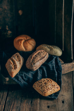 Different types of bread on wooden background