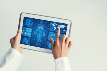 Close of female doctor hands working with tablet pc computer