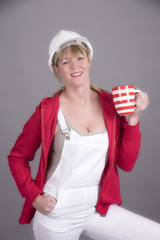 Woman worker wearing a hard hatand holding a mug