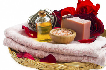 Fototapeta na wymiar Spa beauty roses products with natural soap, massage oil, salt, red roses and soft towels
