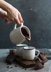 Tuinposter  Pouring Hot chocolate © DragonFly