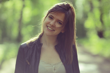 Young adult girl on a walk in the park jacket clothes
