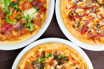 Three Different Types Of Tasty Pizza Shot From Above Closeup
