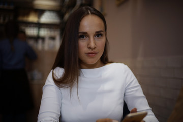 Woman having lunch in summer restaurant blurred background