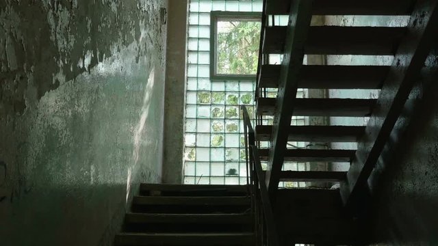 Stairs in the abandoned factory. Smooth and slow dolly shot