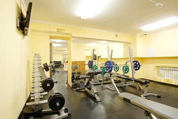 Fototapeta na wymiar Fitness hall with weights and other sport equipment