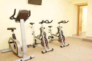 Fototapeta na wymiar Fitness hall with fitness bicicles