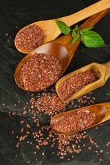Hawaiian red salt on a wooden board. Sale of spices. Advertising for the sale of spices.