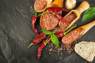 Dried chili peppers and red Hawaiian salt. Sale of spices. Advertising for the sale of spices.