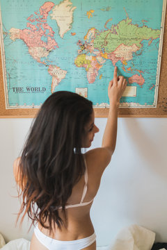 Female pointing to the world map
