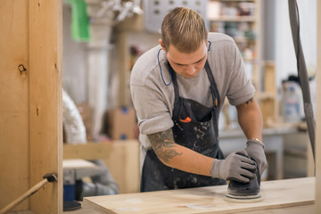 carpenter Using Electric Sander for wood