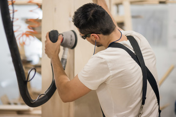 carpenter Using Electric Sander for wood