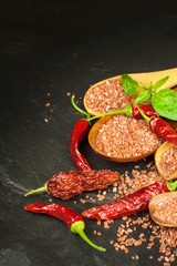 Dried chili peppers and red Hawaiian salt. Sale of spices. Advertising for the sale of spices.