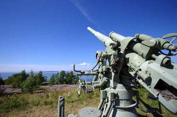 Historical air defense cannon in Suomenlinna. Sunny day with a clear sky.