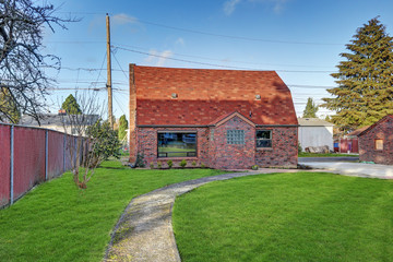 Fototapeta na wymiar Small red brick home on a sunny day