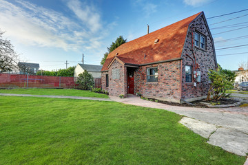 Fototapeta na wymiar Small red brick home on a sunny day