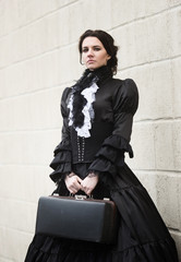 Lady in black with a vintage suitcase