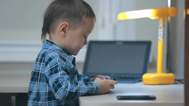 The little boy communicates by tablet