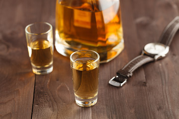 money and whiskey on wooden table. Close-up view