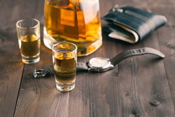money and whiskey on wooden table. Close-up view