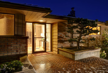 Sunset view of front porch with paved walkway