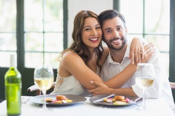 Couple hugging each other in the restaurant