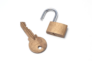 A small padlock and a big key on a white background
