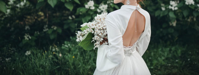Bride with a bouquet on a nature background. 