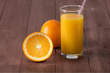 Fresh orange juice with sliced orange on table