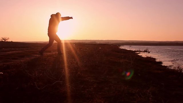 Silhouette of man boxing with shadow on the beatch at sunset intentional sun flare and vintage color. Man Engaged In Melee Combat Sports Boxing At Sport Sunset Shadow Boxing