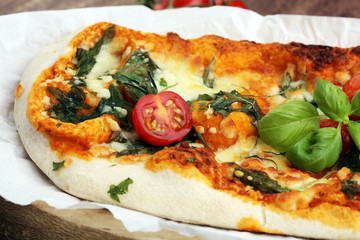 Hot pizza slice with melting cheese on a rustic wooden table.
