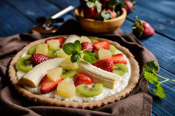 Fruit pizza with banana, kiwi, strawberry, pineapple