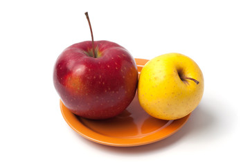 Apple on a orange plate isolated white background