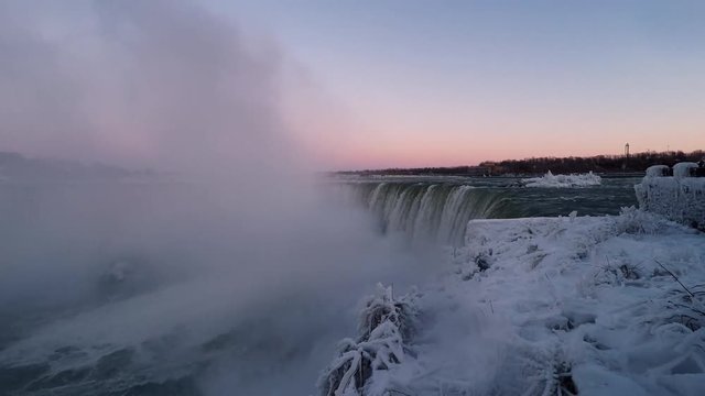Niagara Horseshoe Falls winter landscape of ice and snow wonderland at dusk time lapse video footage