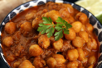 Chana Masala indian dish spicy Chick Peas also known as Chola Masala or Chole served in a white bowl