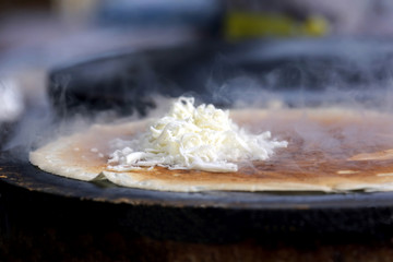 cooking pancakes stuffed with cheese.