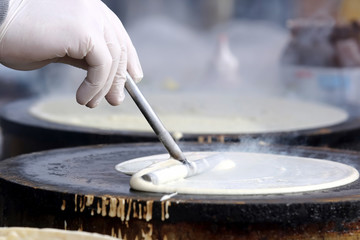 Obraz na płótnie Canvas making pancakes on the stove